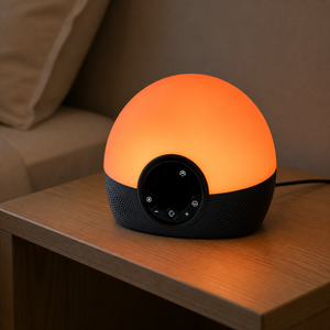 Sunrise alarm clock glowing orange in an evening bedroom